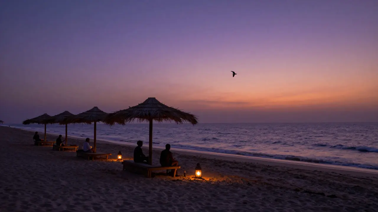 Beachcomber at Jumeirah Al Naseem during quiet sunset, lanterns and palm cabanas by calm waves.
