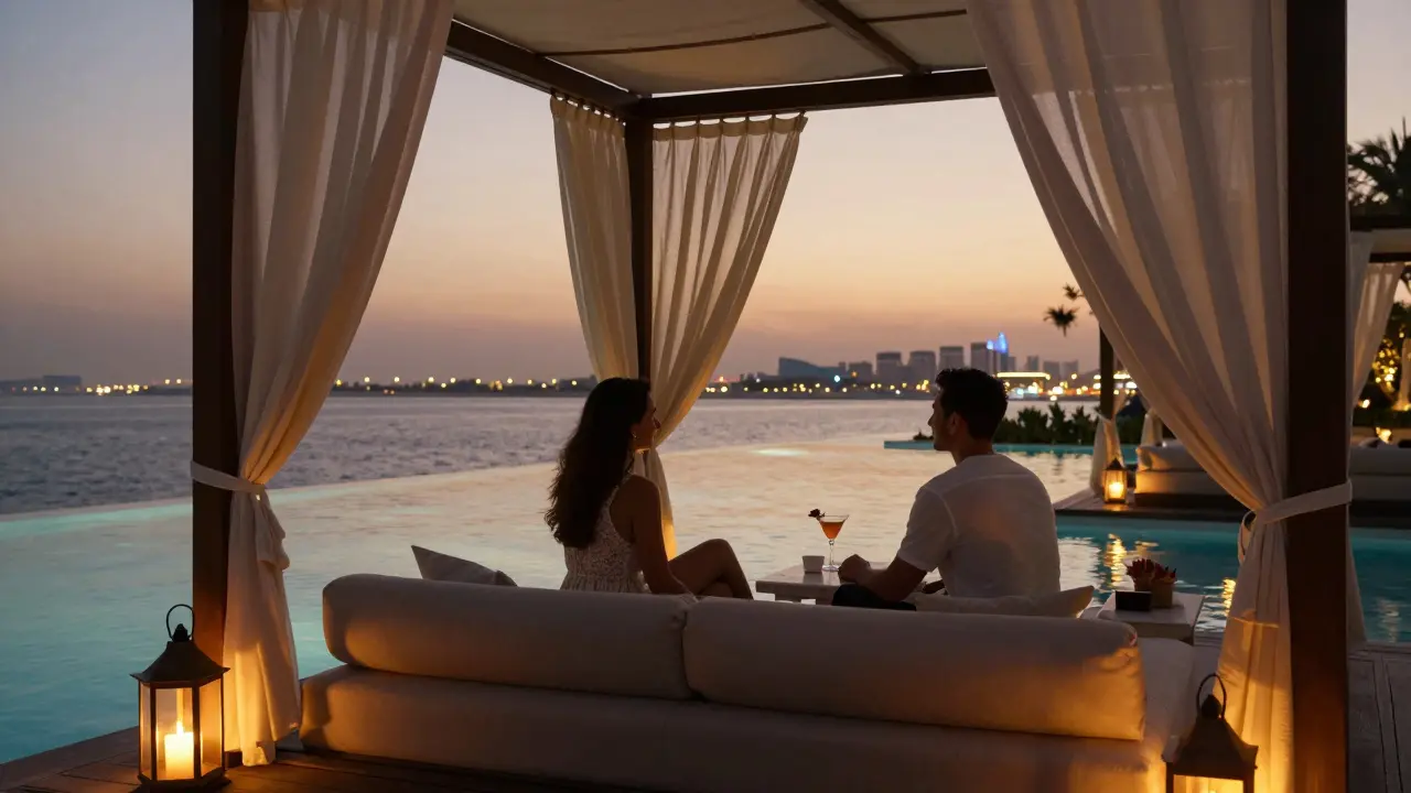 Two people relaxing in a private cabana by a glowing pool at sunset in Dubai.